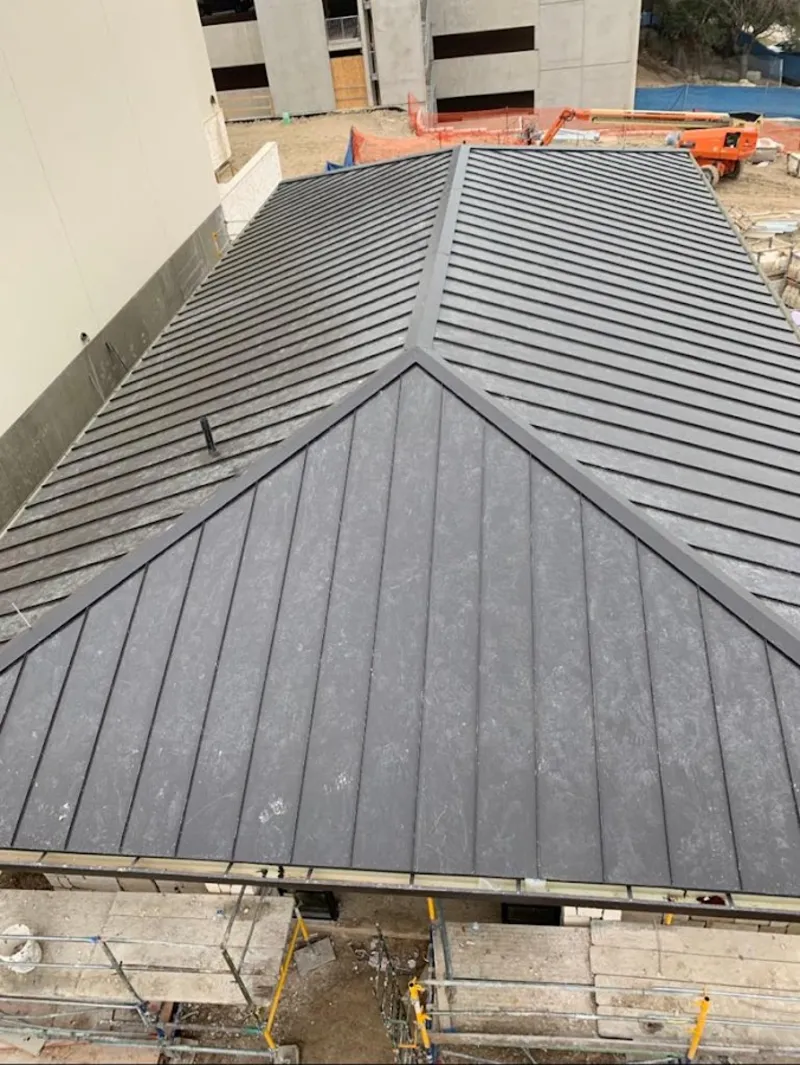 Commercial metal roof construction with crane equipment in Opelousas
