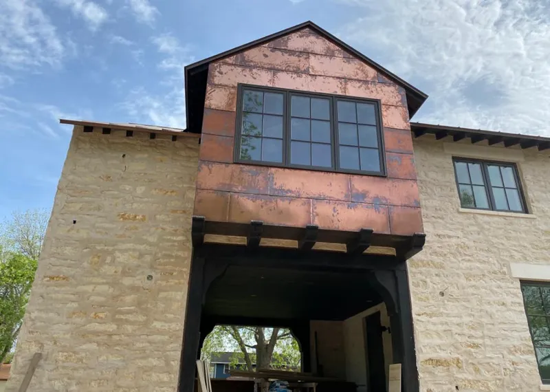 Copper metal panel facade on a stone building for Skylight Installation in Opelousas